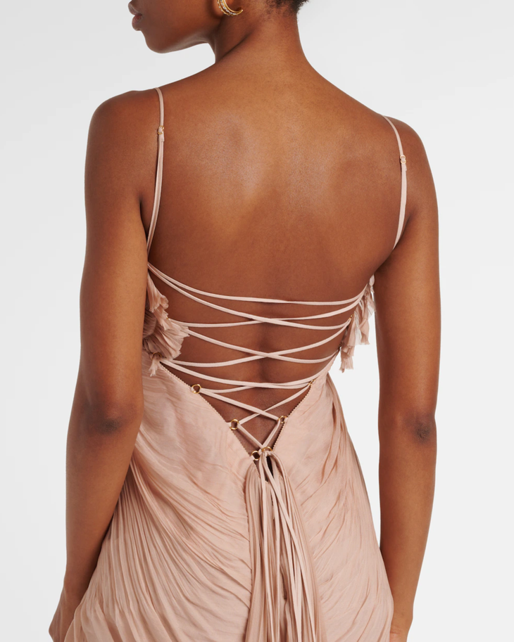 Rear view of woman wearing blush pink silk gown with intricate lace-up corset back detail — Maria Lucia Hohan | Endless UAE