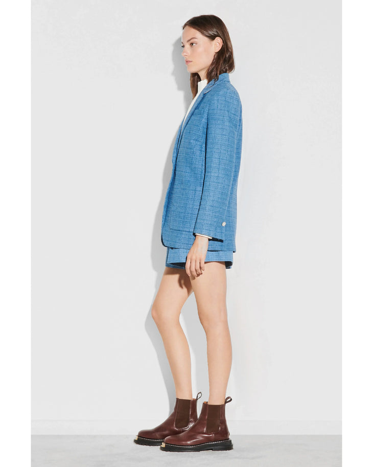 Blue geometric knit blazer worn with white shirt and burgundy boots — Sandro | Endless UAE