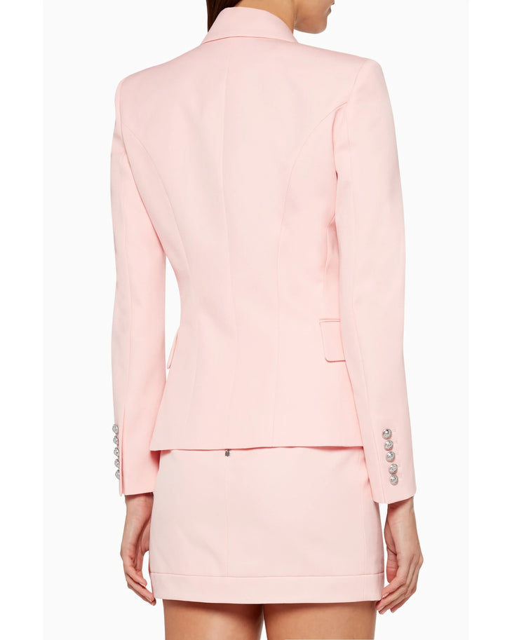 Woman wearing pink double-breasted Balmain blazer with matching skirt and black heels — Balmain | Endless UAE