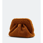 Gea Clutch in caramel brown textured fabric held in hand — TheMoire | Endless UAE