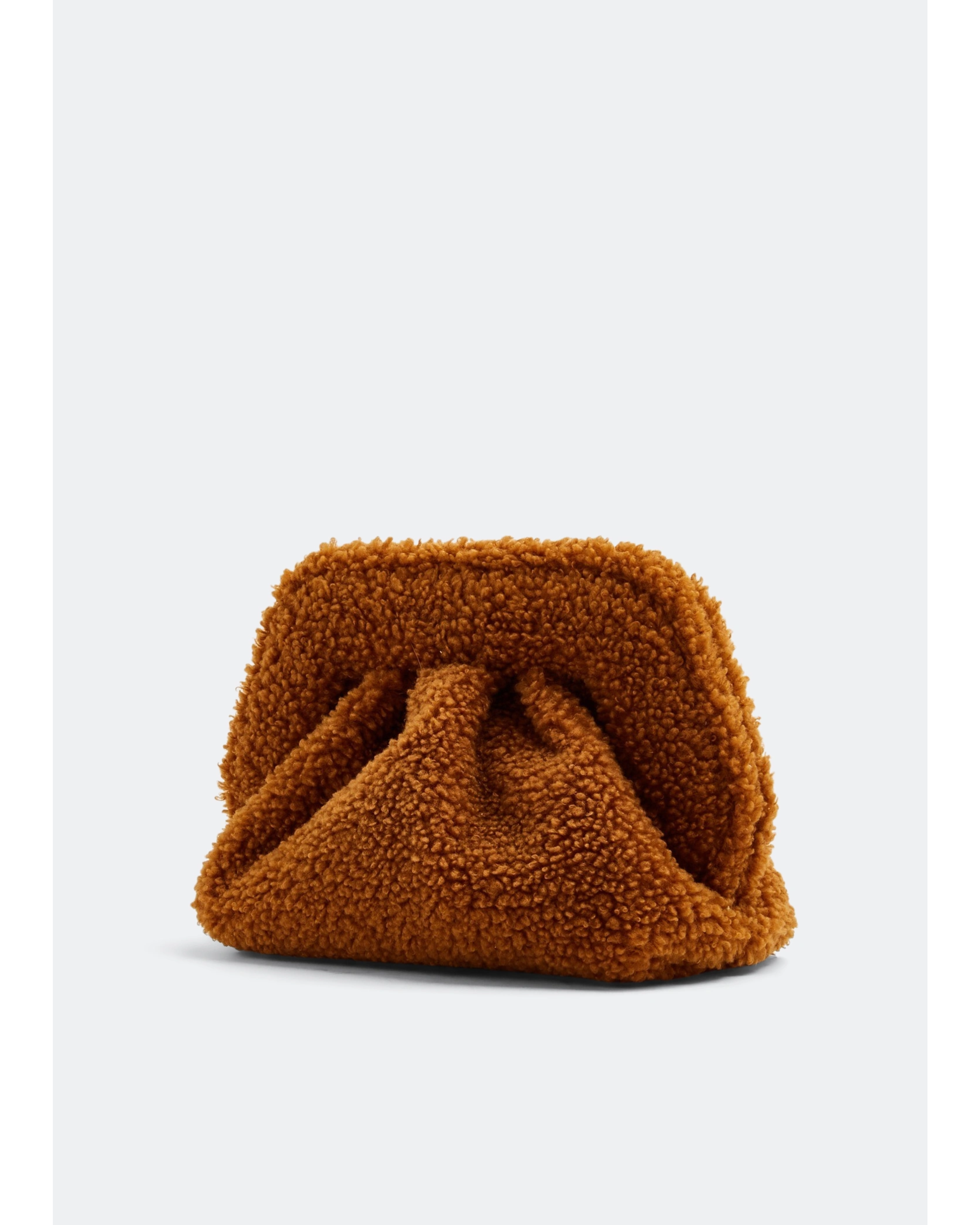Gea Clutch in caramel brown textured fabric held in hand — TheMoire | Endless UAE