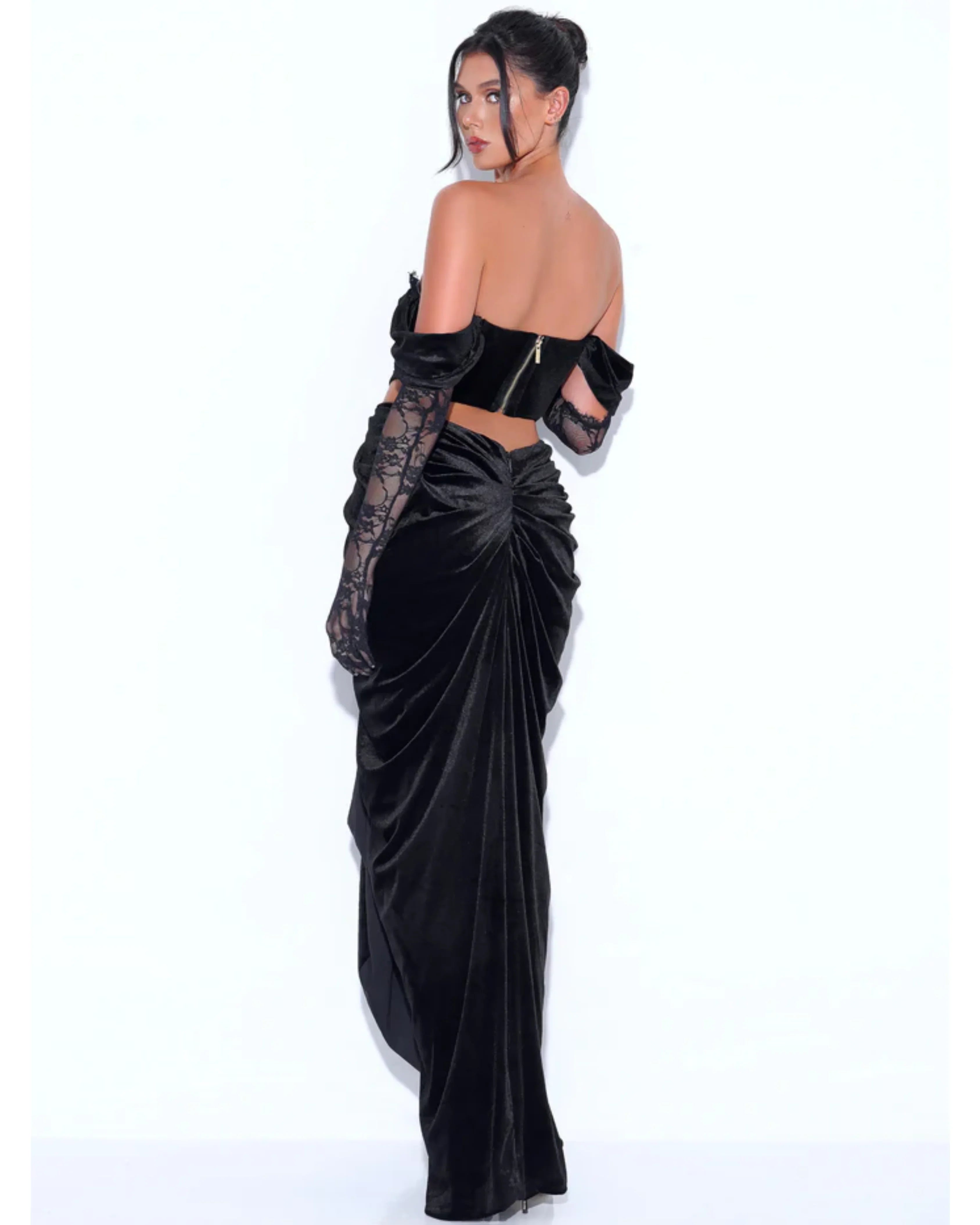 Black velvet off-shoulder gown with lace detailing and corset bodice, featuring draped skirt and cutout back — Miss Circle | Endless UAE.