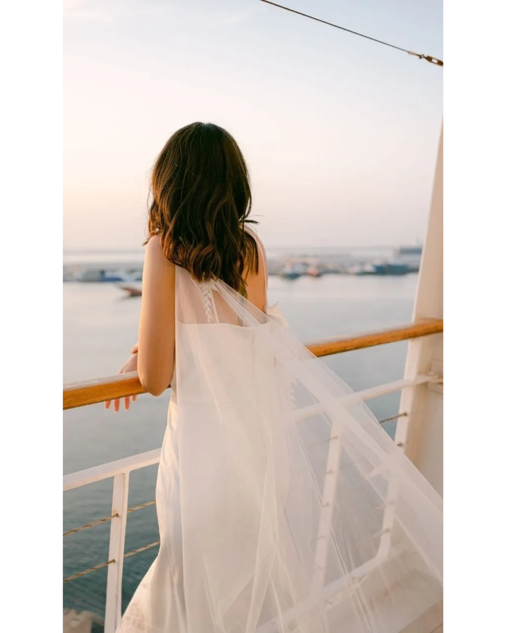 Bride in white convertible wedding dress with floral embellishments and flowing train — Dressarte Paris | Endless UAE