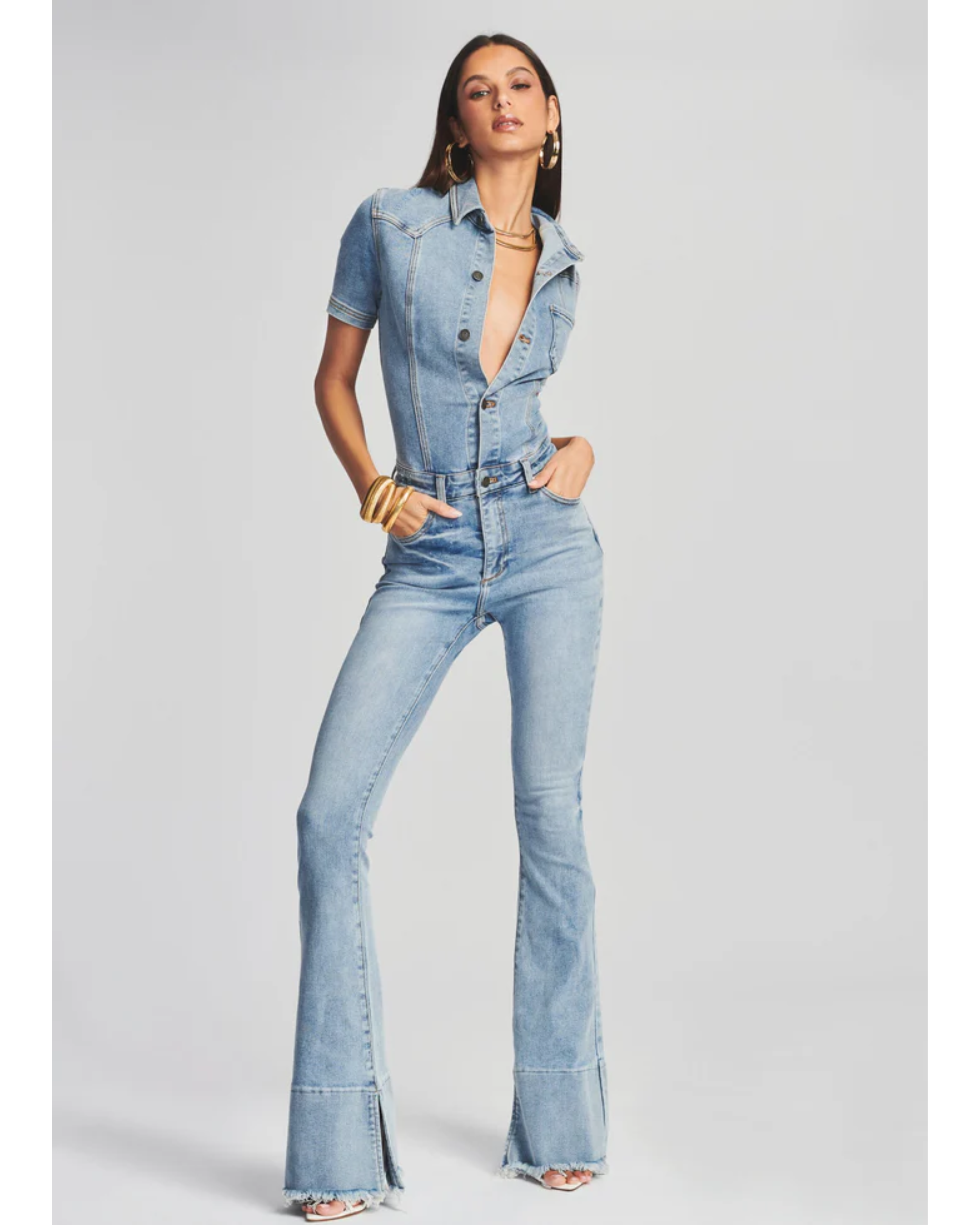 Woman wearing light blue denim Fallon Jumpsuit with short sleeves and flared legs — SER.O.YA | Endless UAE