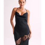 Woman wearing black satin maxi dress with lace side detail and halter neckline — Meshki | Endless UAE