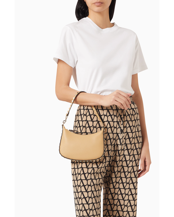 Beige leather mini hobo shoulder bag with dark brown studded trim and single strap — Valentino Garavani | Endless UAE