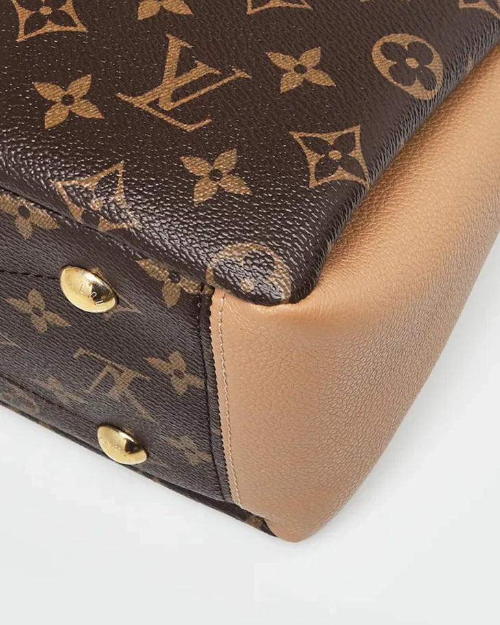 Classic Louis Vuitton monogram canvas bag with beige leather trim and gold hardware feet detail — Louis Vuitton | Endless UAE