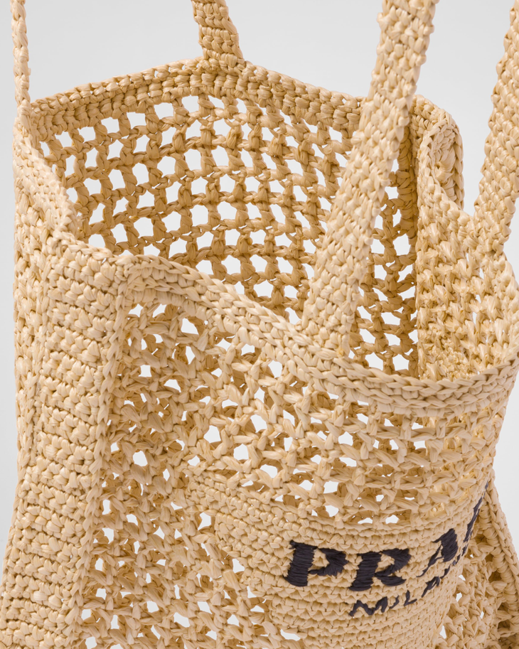 Natural woven raffia tote bag with open mesh weave design, triangle logo patch, and dual shoulder straps — Prada | Endless UAE