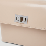Beige patent leather shoulder bag with dual compartments and silver turnlock closures — Endless | Endless UAE