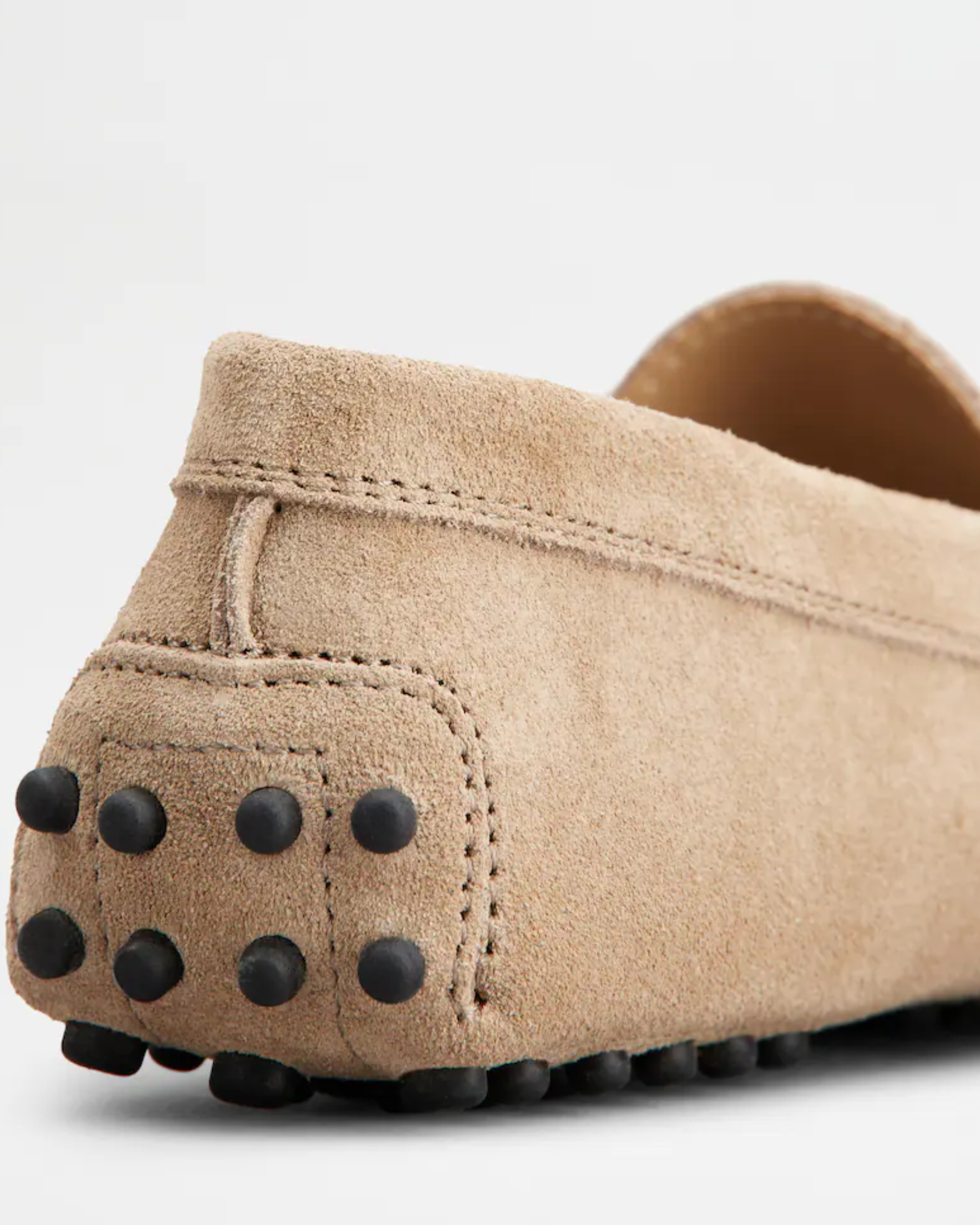 Beige suede junior driving loafer with black rubber sole and stitched detailing — Tod's | Endless UAE