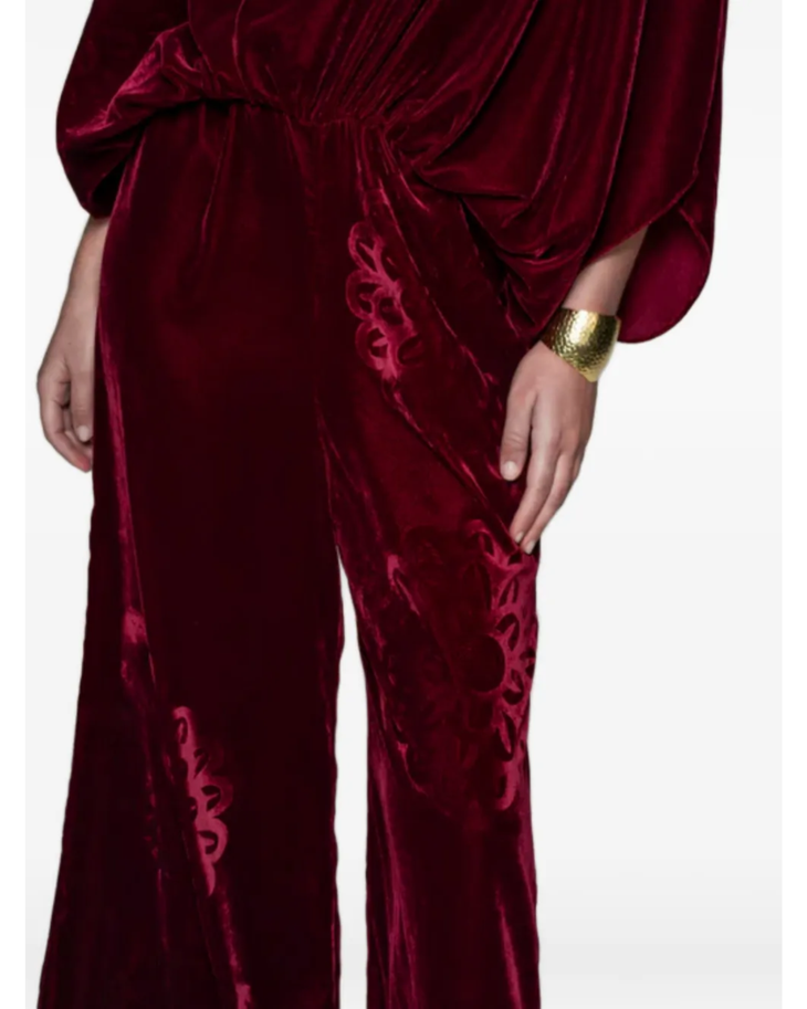 Woman wearing burgundy silk velvet jumpsuit with ornamental detailing and wide legs — Themis-Z | Endless UAE