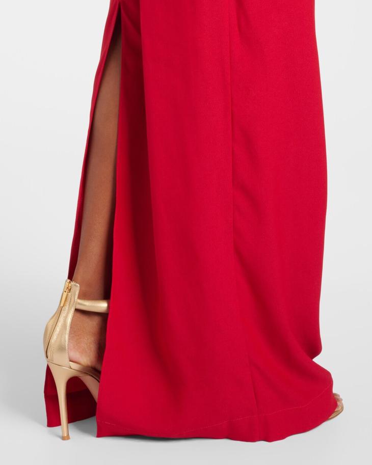 Red evening gown with dramatic side slit detail, worn with gold heels — Taller Marmo | Endless UAE