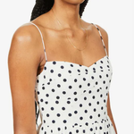 Woman wearing white organic cotton-blend midi dress with black polka dots and thin spaghetti straps — Reformation | Endless UAE
