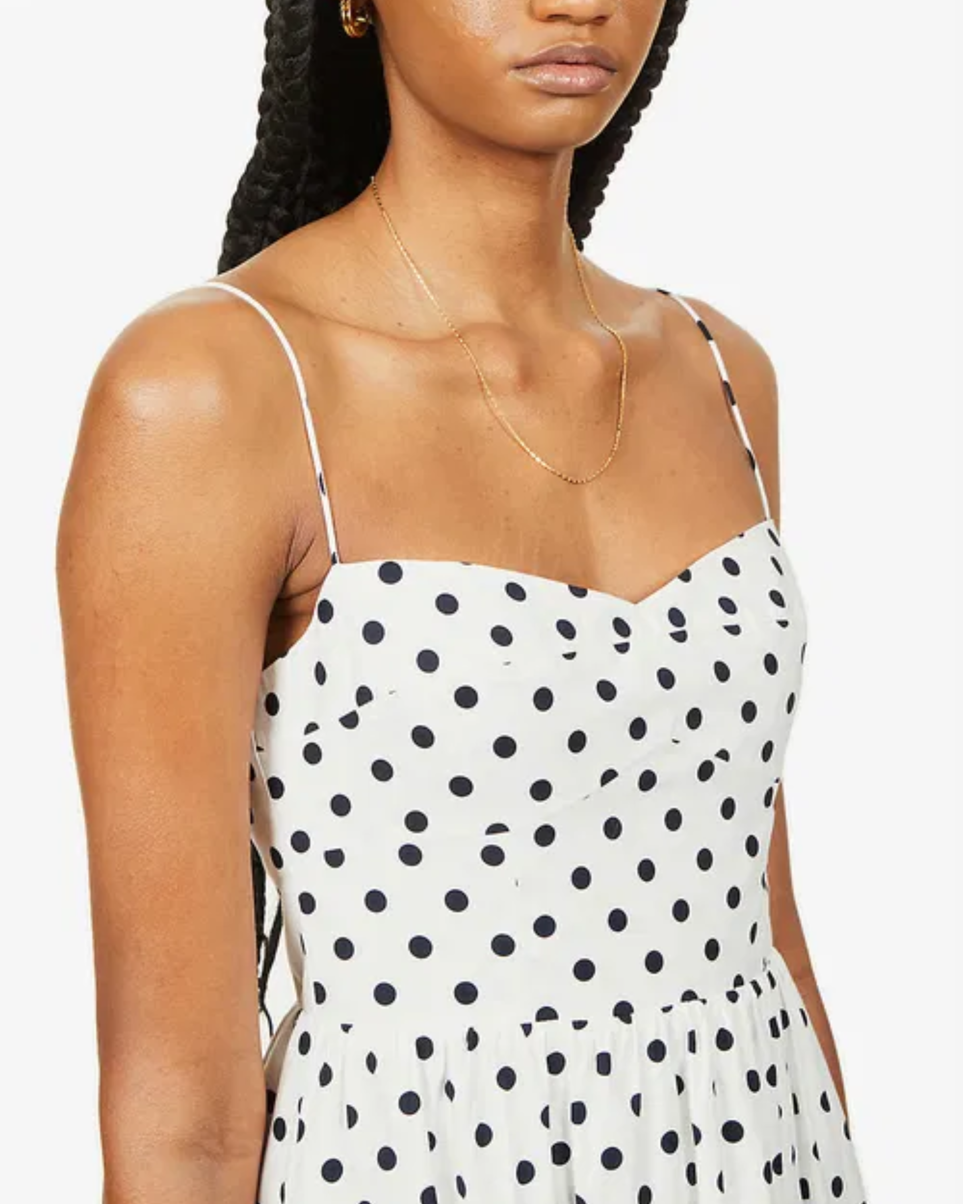 Woman wearing white organic cotton-blend midi dress with black polka dots and thin spaghetti straps — Reformation | Endless UAE