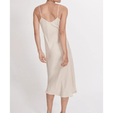 Woman wearing cream spaghetti strap slip dress with black strappy heels — Silk Laundry | Endless UAE