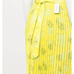 Yellow pleated floral midi skirt with asymmetric hem paired with white tank top and cardigan — Rokh | Endless UAE