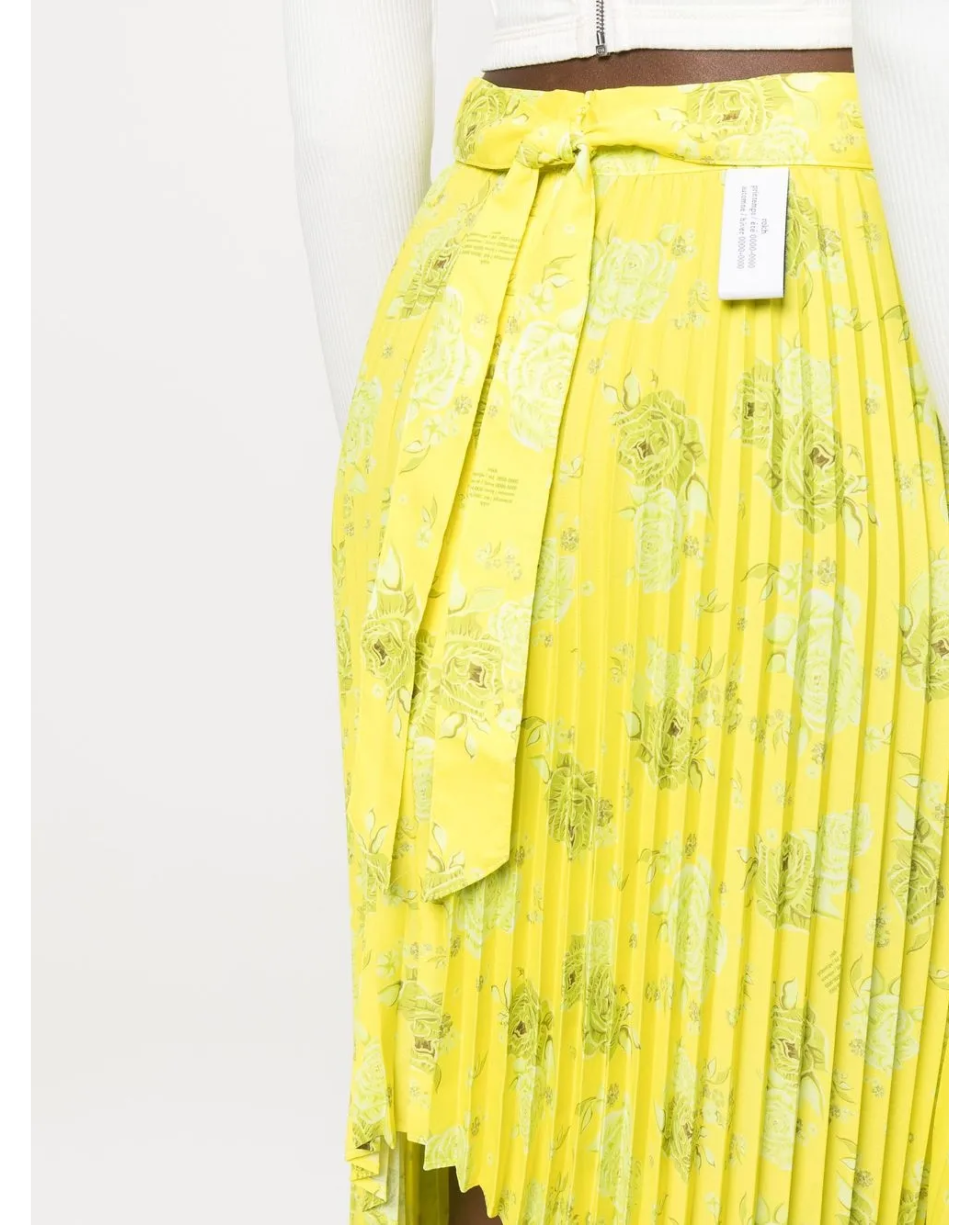 Yellow pleated floral midi skirt with asymmetric hem paired with white tank top and cardigan — Rokh | Endless UAE