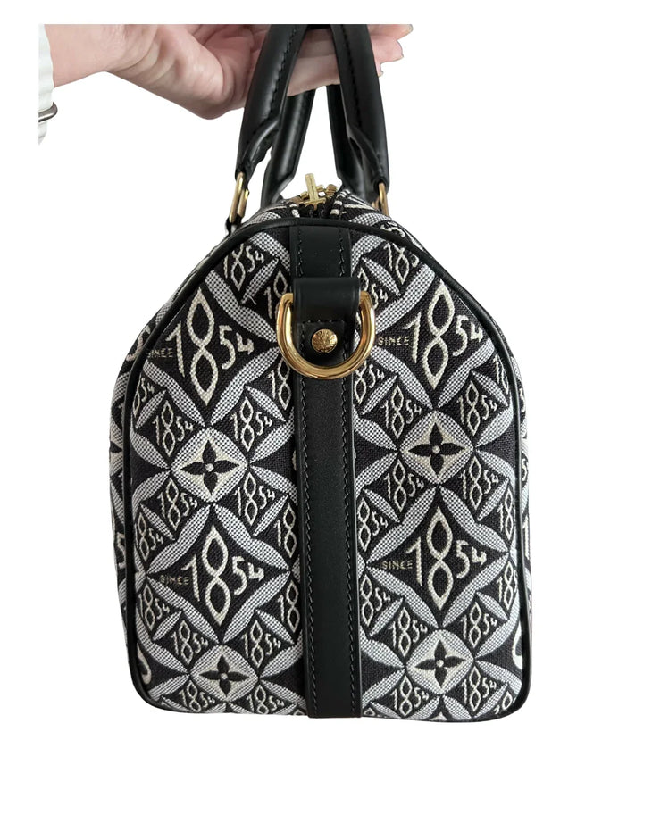 Louis Vuitton Since 1854 Speedy Bandouliere 25 handbag in monogram jacquard with black leather trim and gold hardware — Louis Vuitton | Endless UAE