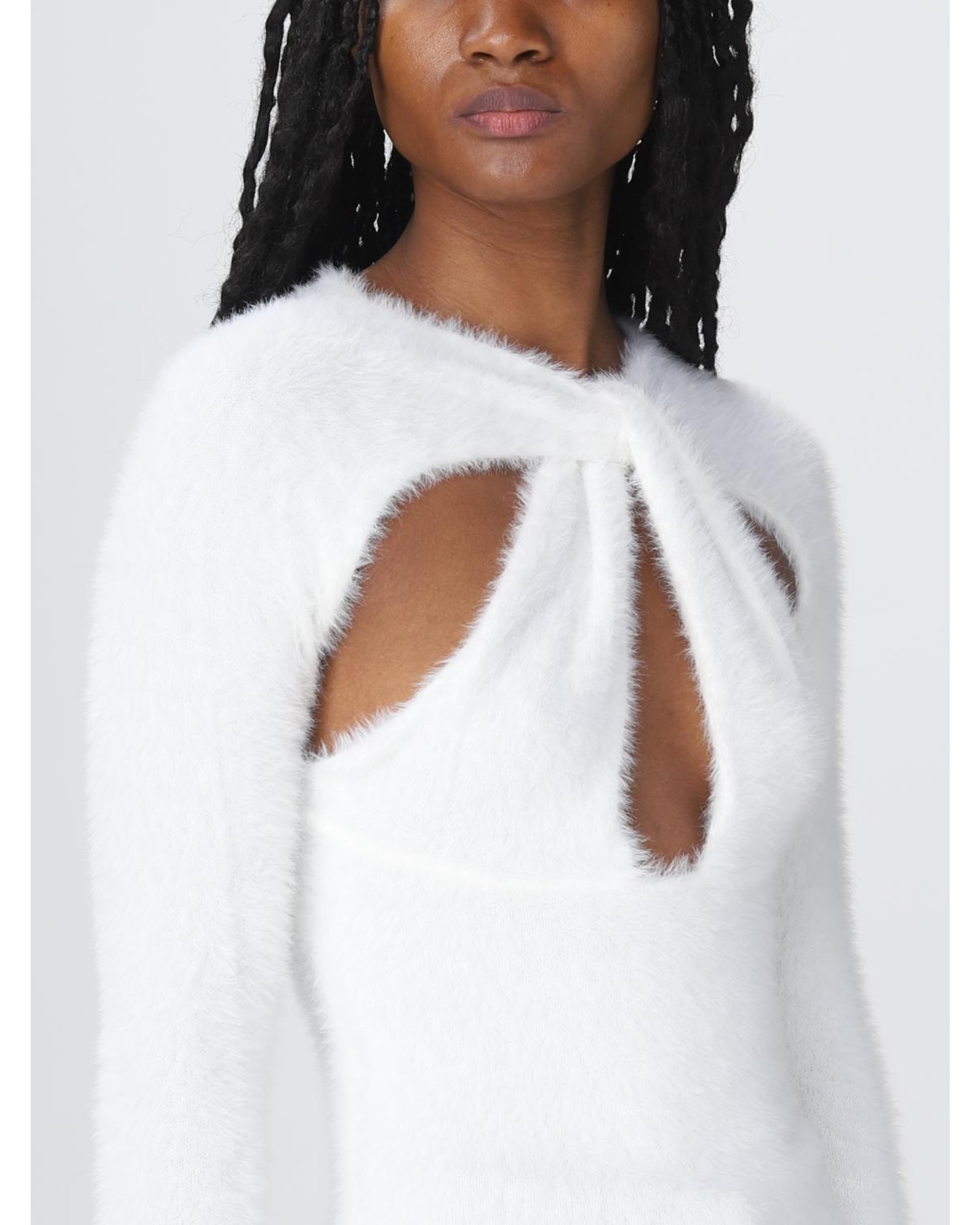 White fuzzy sweater with dramatic cutout detail at chest worn by model with braided hair — Coperni | Endless UAE