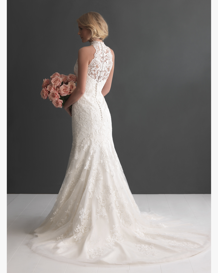 Lace mermaid wedding dress with high neck illusion back and chapel train holding pink roses — Allure Romance | Endless UAE