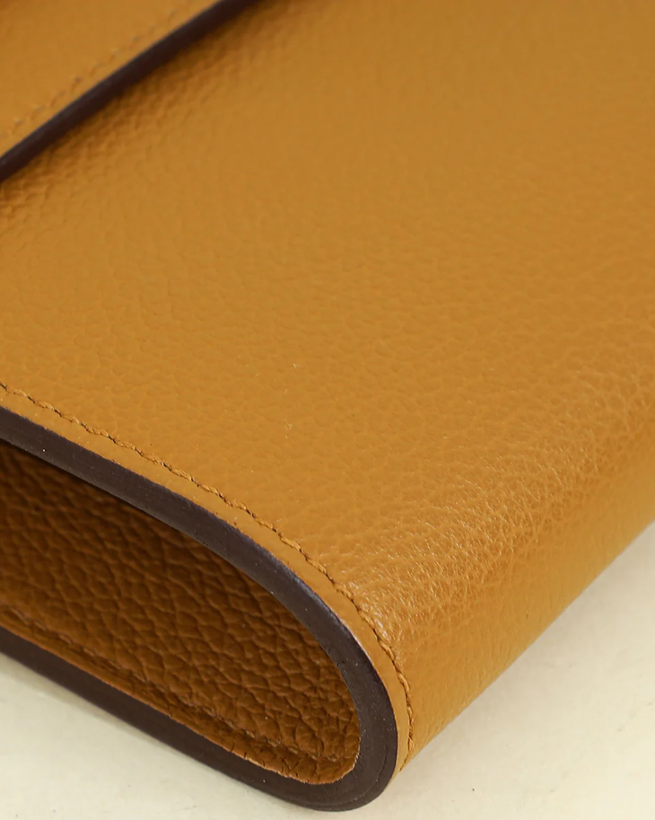 Mustard yellow Sesame Kelly To Go Evercolor wallet with dark brown trim and visible stitching detail — Hermes | Endless UAE