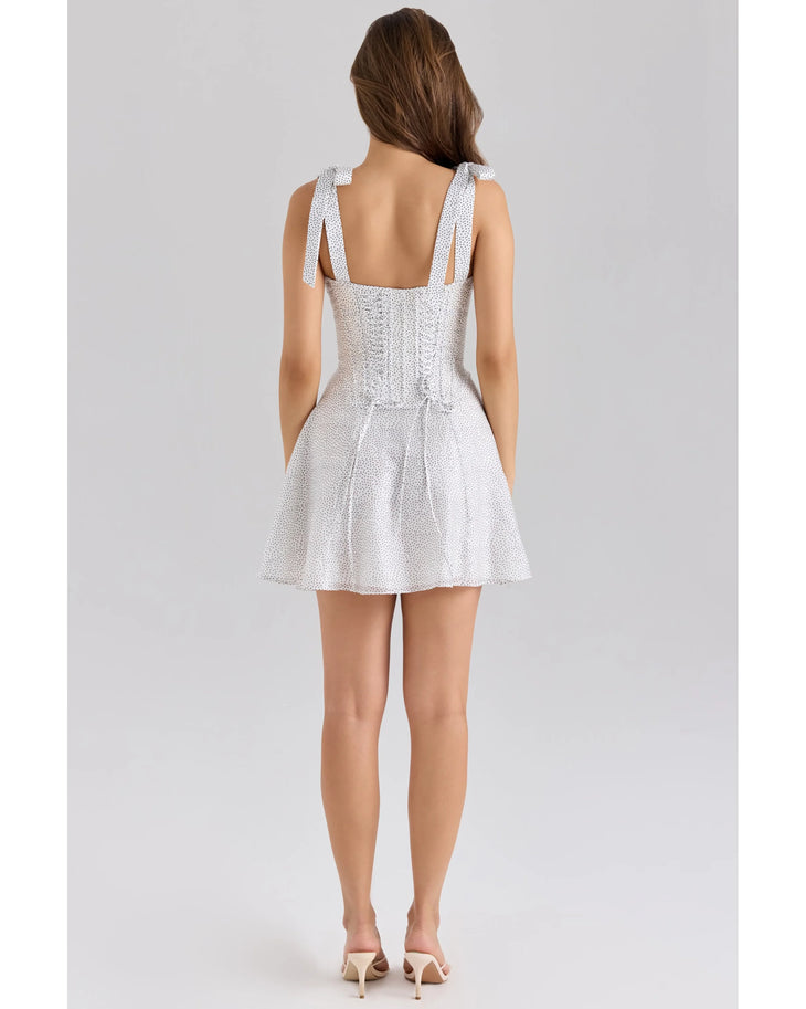 Woman wearing white chiffon mini dress with dot print and tie-shoulder straps — House Of CB | Endless UAE