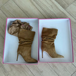 Camel velour slouchy knee-high boots with pointed toe and stiletto heel displayed in pink boxes on wooden floor — Paris Texas | Endless UAE