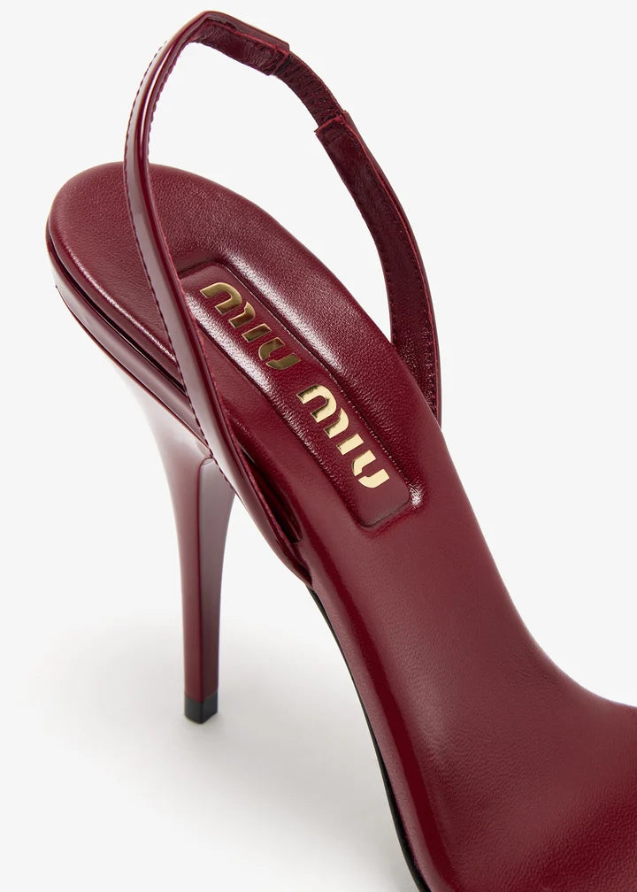 Burgundy patent leather sandal with thin straps and high stiletto heel — Miu Miu | Endless UAE