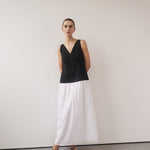 Woman wearing black and white color-block midi dress with V-neckline and black strappy sandals — DISSH | Endless UAE
