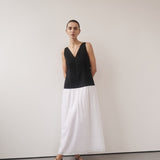 Woman wearing black and white color-block midi dress with V-neckline and black strappy sandals — DISSH | Endless UAE