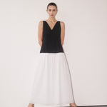 Woman wearing black and white color-block midi dress with V-neckline and black strappy sandals — DISSH | Endless UAE