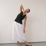 Woman wearing black and white color-block midi dress with V-neckline and black strappy sandals — DISSH | Endless UAE