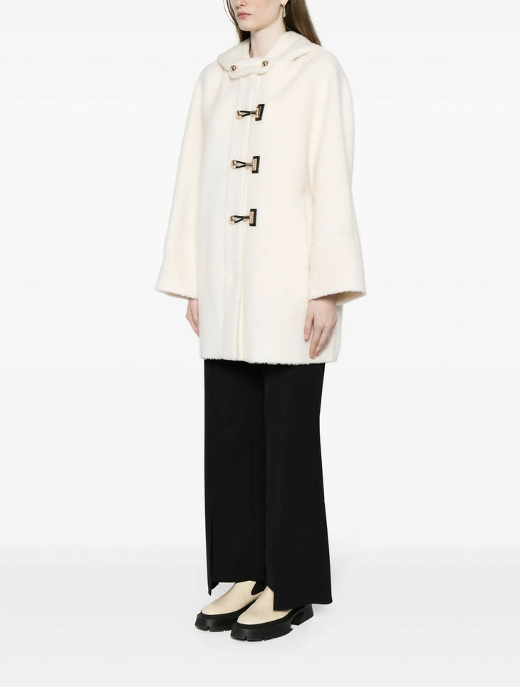 Cream hooded wool-blend coat with toggle closures and wide sleeves, worn with black wide-leg trousers — B+ab | Endless UAE