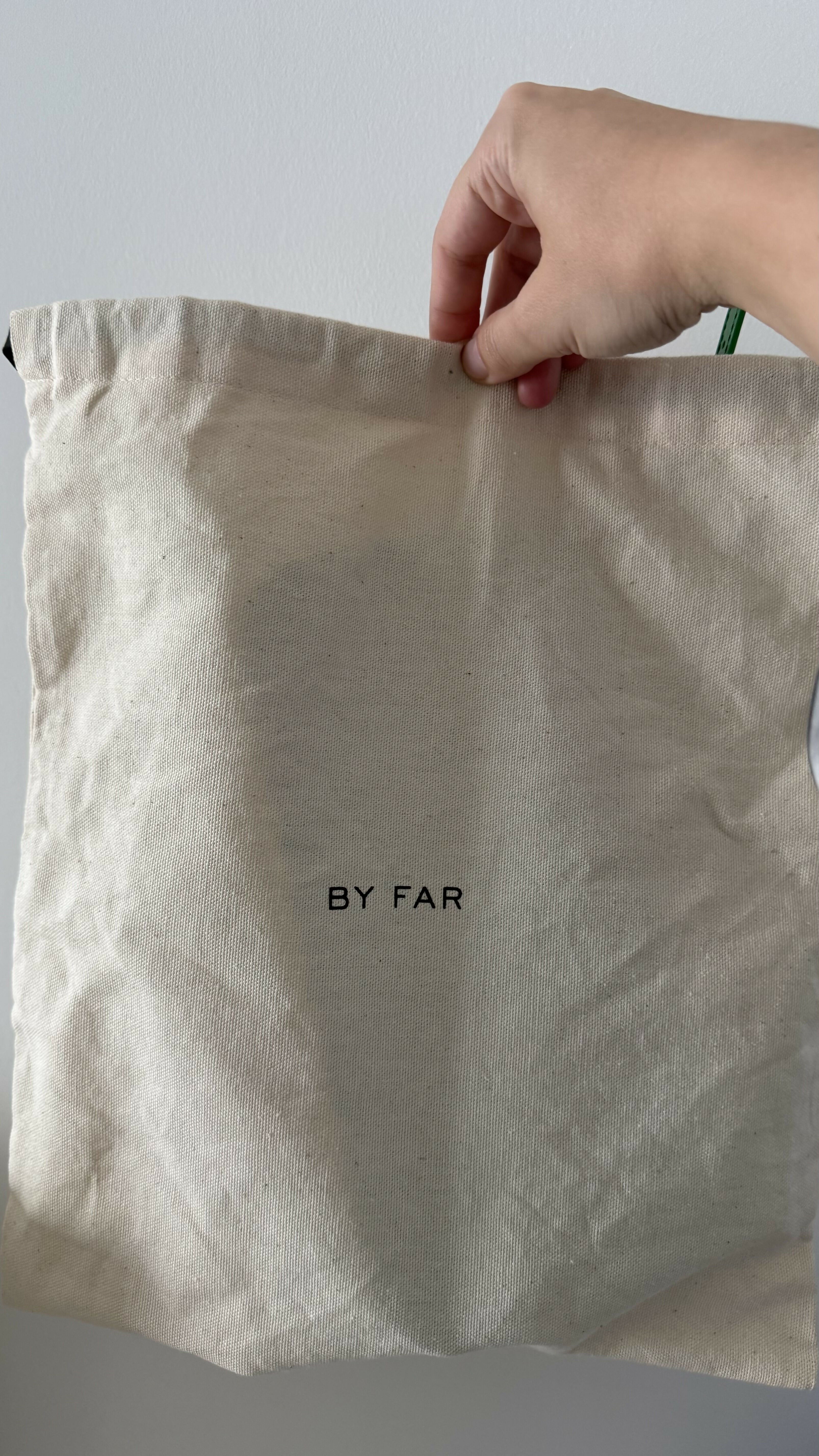 Dulce Patent Leather Shoulder Bag in vibrant green, held up against neutral background — By Far | Endless UAE