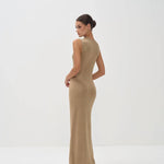 Elegant gold sleeveless maxi dress with form-fitting silhouette, shown from back on model with hair in bun — Nora The Label | Endless UAE