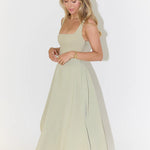 Woman wearing sage green square neck midi dress with full skirt and pockets — Odd Muse | Endless UAE