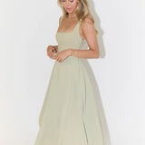 Woman wearing sage green square neck midi dress with full skirt and pockets — Odd Muse | Endless UAE