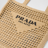 Natural raffia tote bag with black Prada Milano logo and open weave crochet design — Prada | Endless UAE