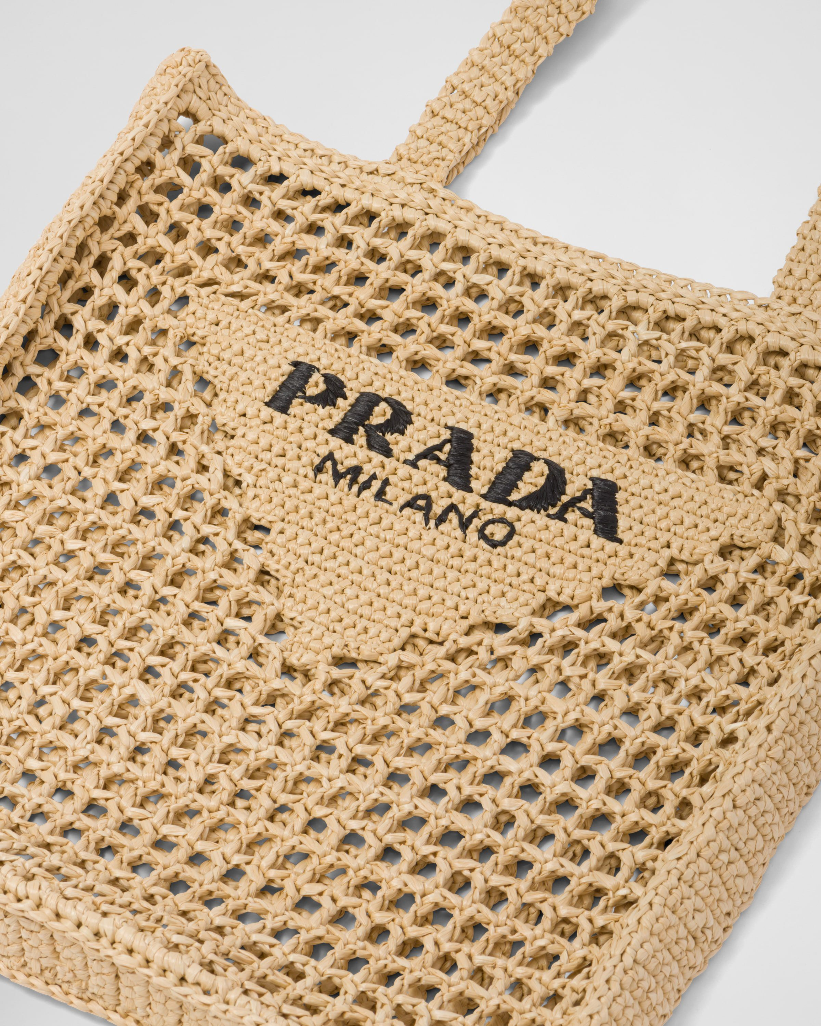 Natural raffia tote bag with black Prada Milano logo and open weave crochet design — Prada | Endless UAE