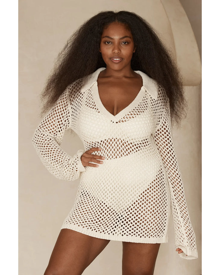 Woman wearing cream knit Newport Dress on beach with arms raised — Monday Swimwear | Endless UAE