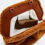 Gea Clutch in caramel brown textured fabric held in hand — TheMoire | Endless UAE