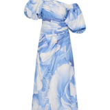 Woman wearing blue and white abstract print Cadence Ruched Midi Dress with puffed sleeves and white slides — Aje | Endless UAE