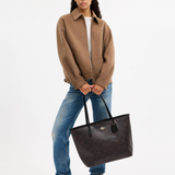 Black leather tote bag with dual handles and Coach branding — Coach | Endless UAE
