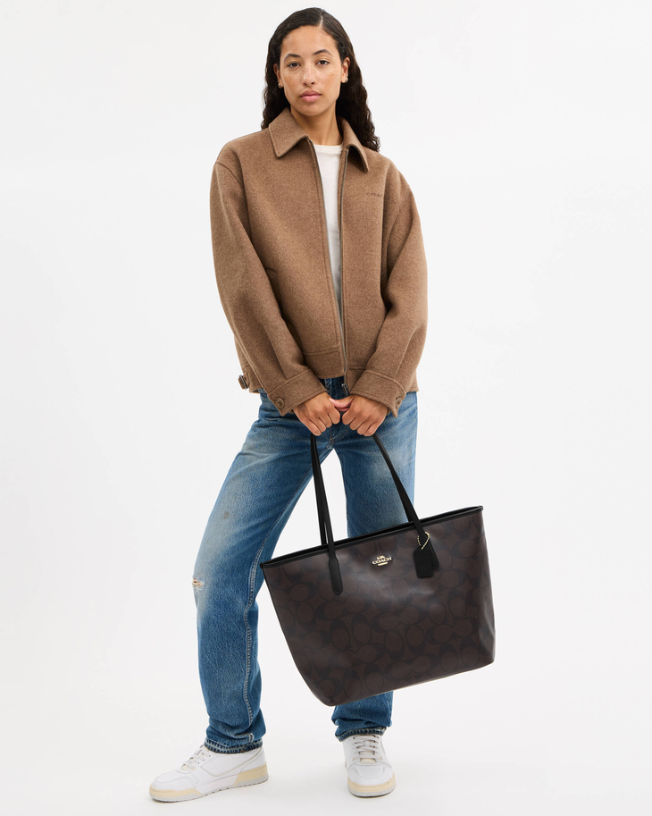 Black leather tote bag with dual handles and Coach branding — Coach | Endless UAE