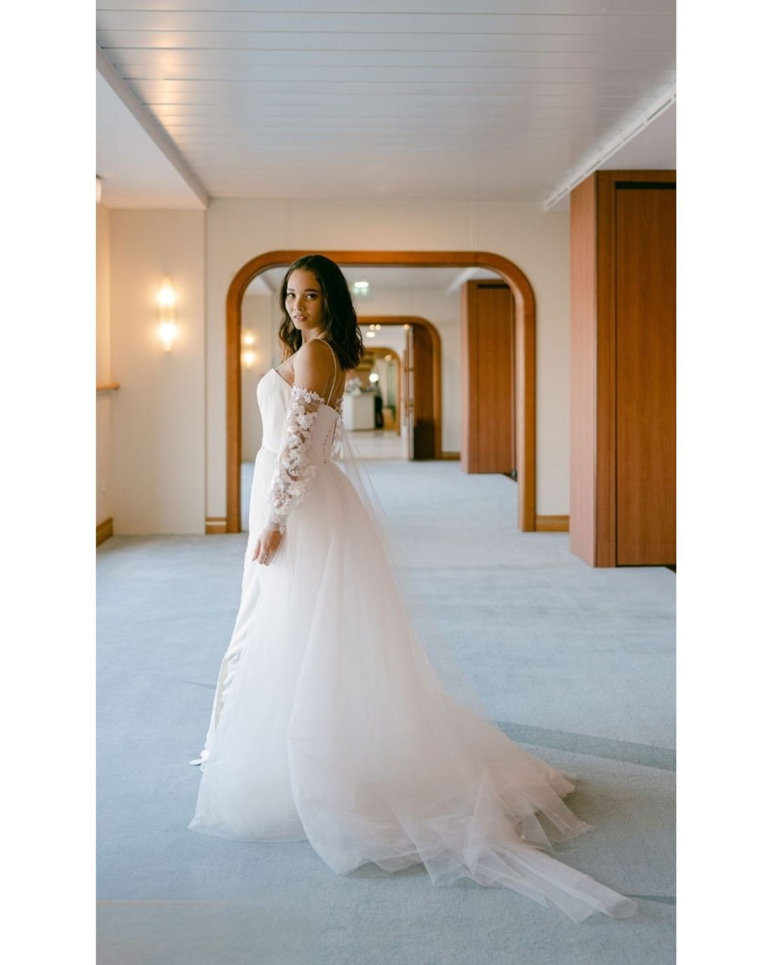 Bride in white convertible wedding dress with floral embellishments and flowing train — Dressarte Paris | Endless UAE