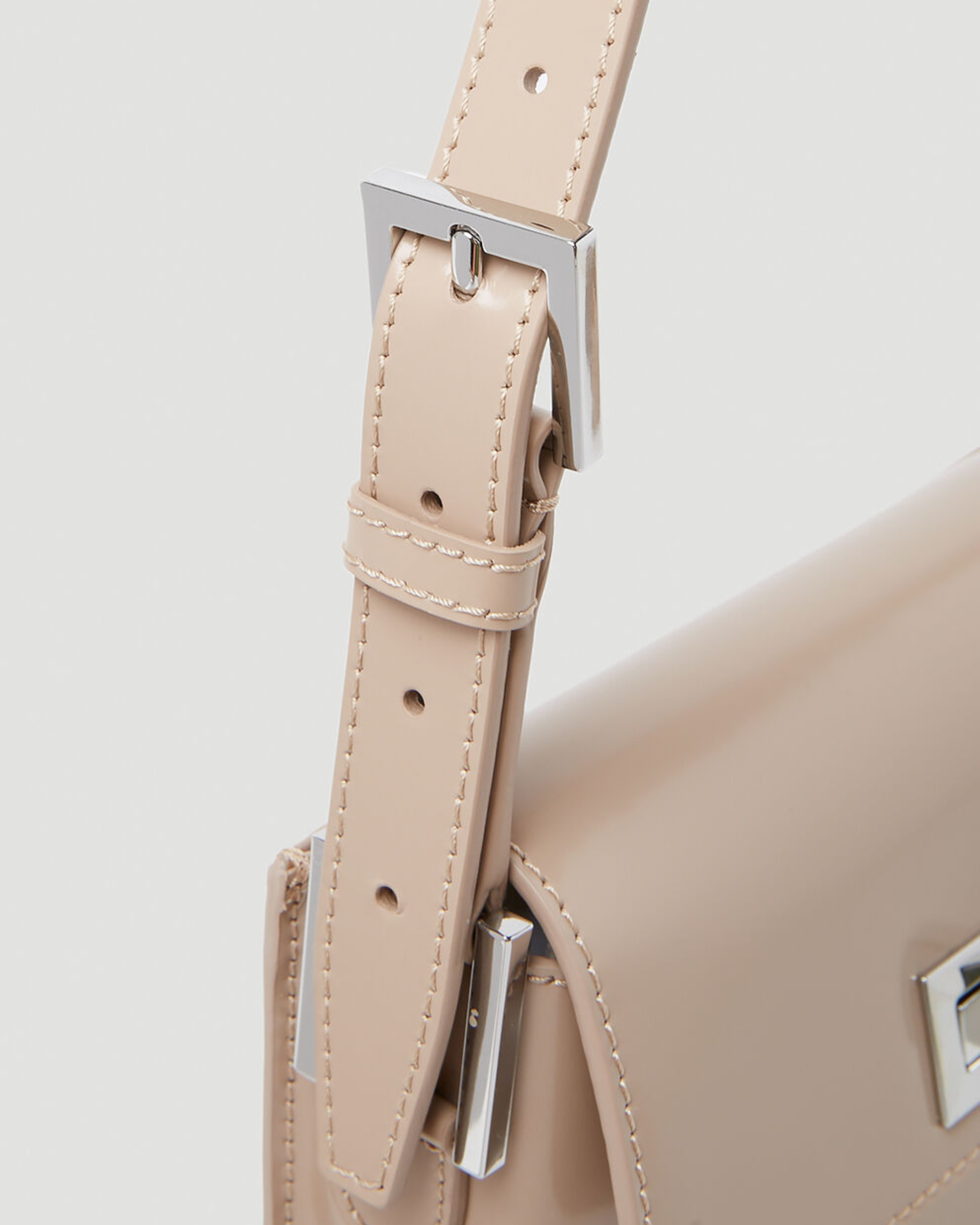 Beige patent leather shoulder bag with dual compartments and silver turnlock closures — Endless | Endless UAE