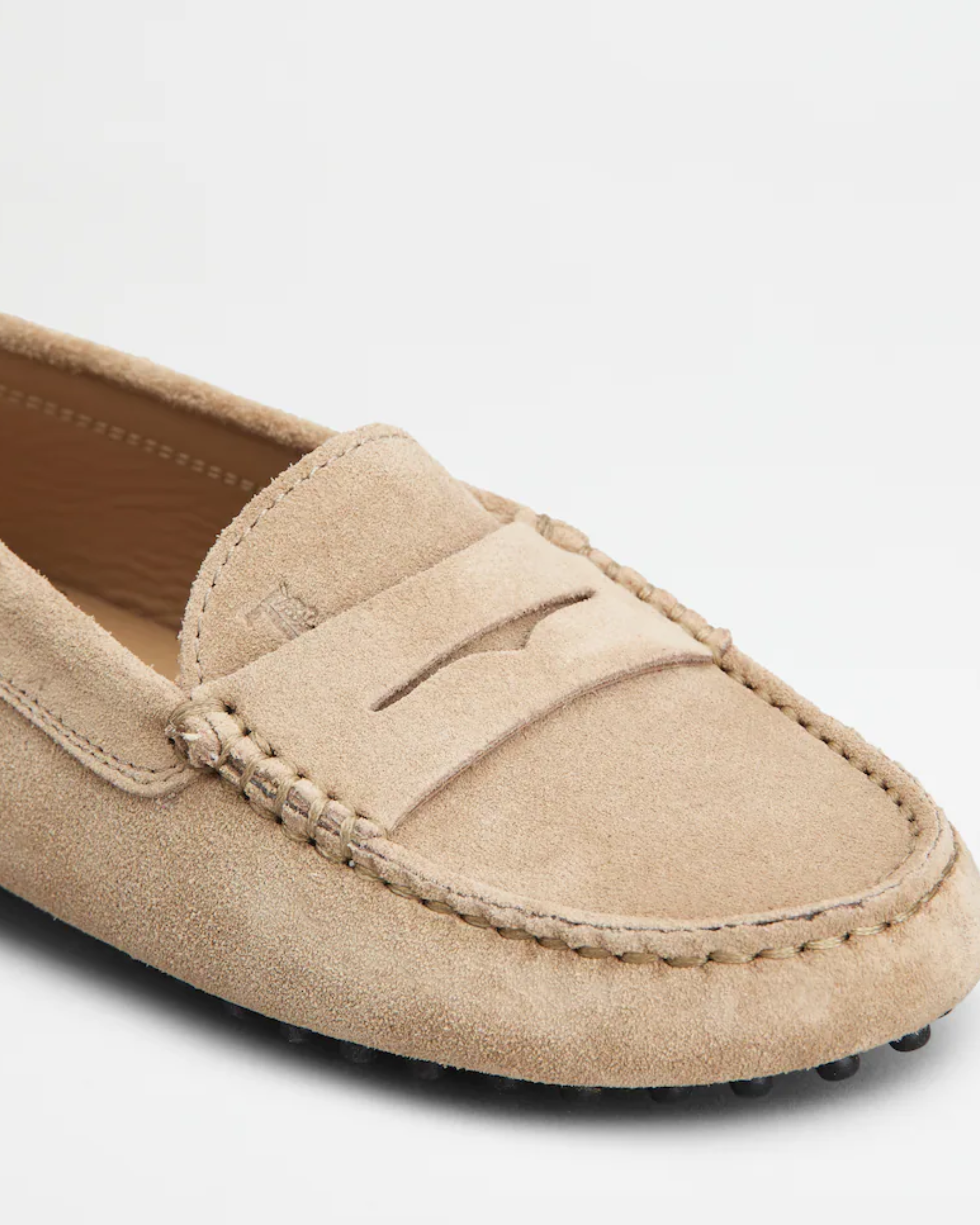 Beige suede junior driving loafer with black rubber sole and stitched detailing — Tod's | Endless UAE