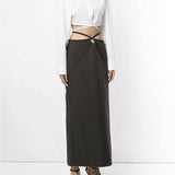 White cropped silk shirt with wrap-around tie detail and exposed midriff paired with black maxi skirt — Christopher Esber | Endless UAE