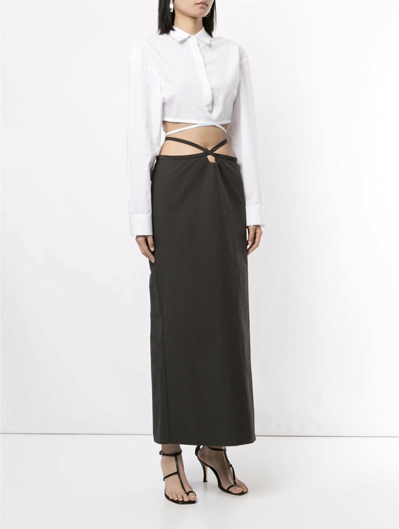 White cropped silk shirt with wrap-around tie detail and exposed midriff paired with black maxi skirt — Christopher Esber | Endless UAE
