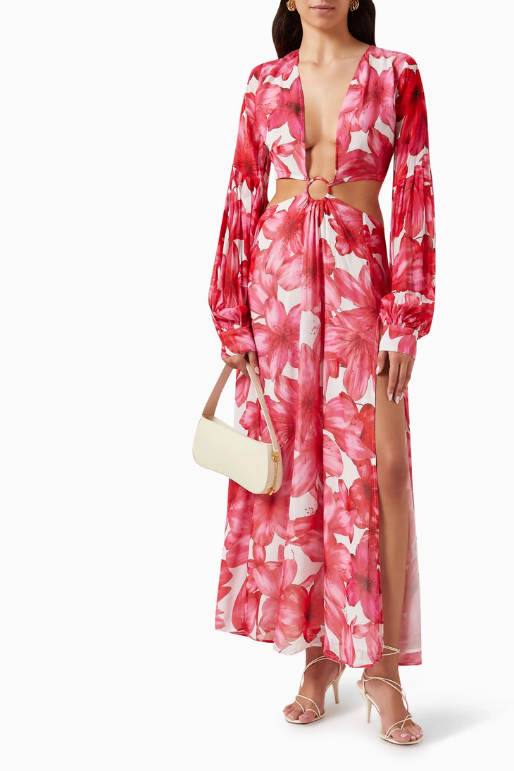 Woman wearing red floral cut-out maxi dress with long sleeves and gold sandals — Alexandra Miro | Endless UAE